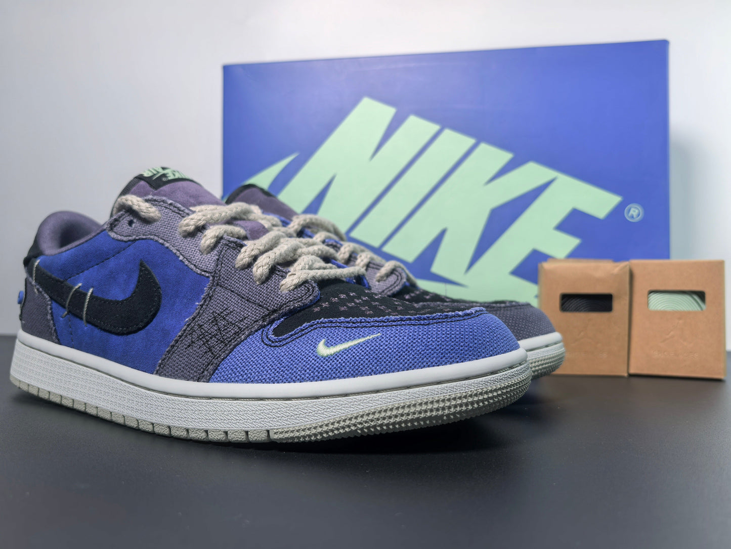 Premium blue and black Nike sneakers with extra laces and branded box, luxury urban wear