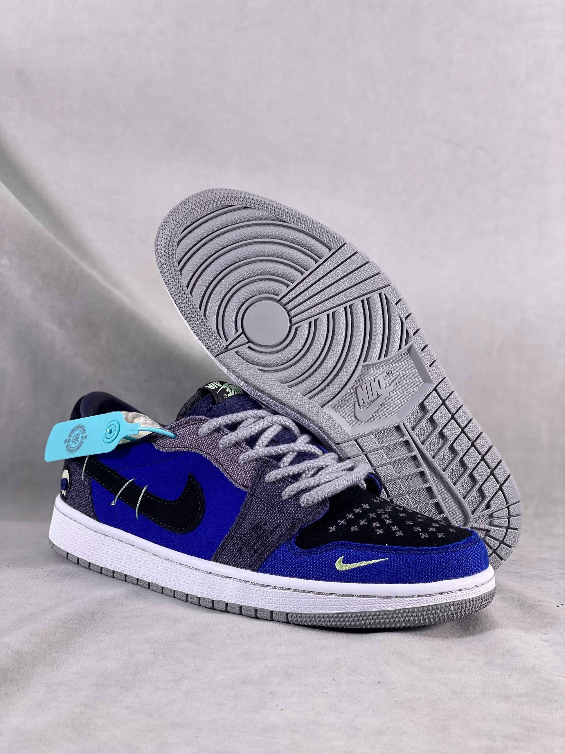 Luxury urban wear premium blue and black low-top Nike sneakers with unique sole and tag