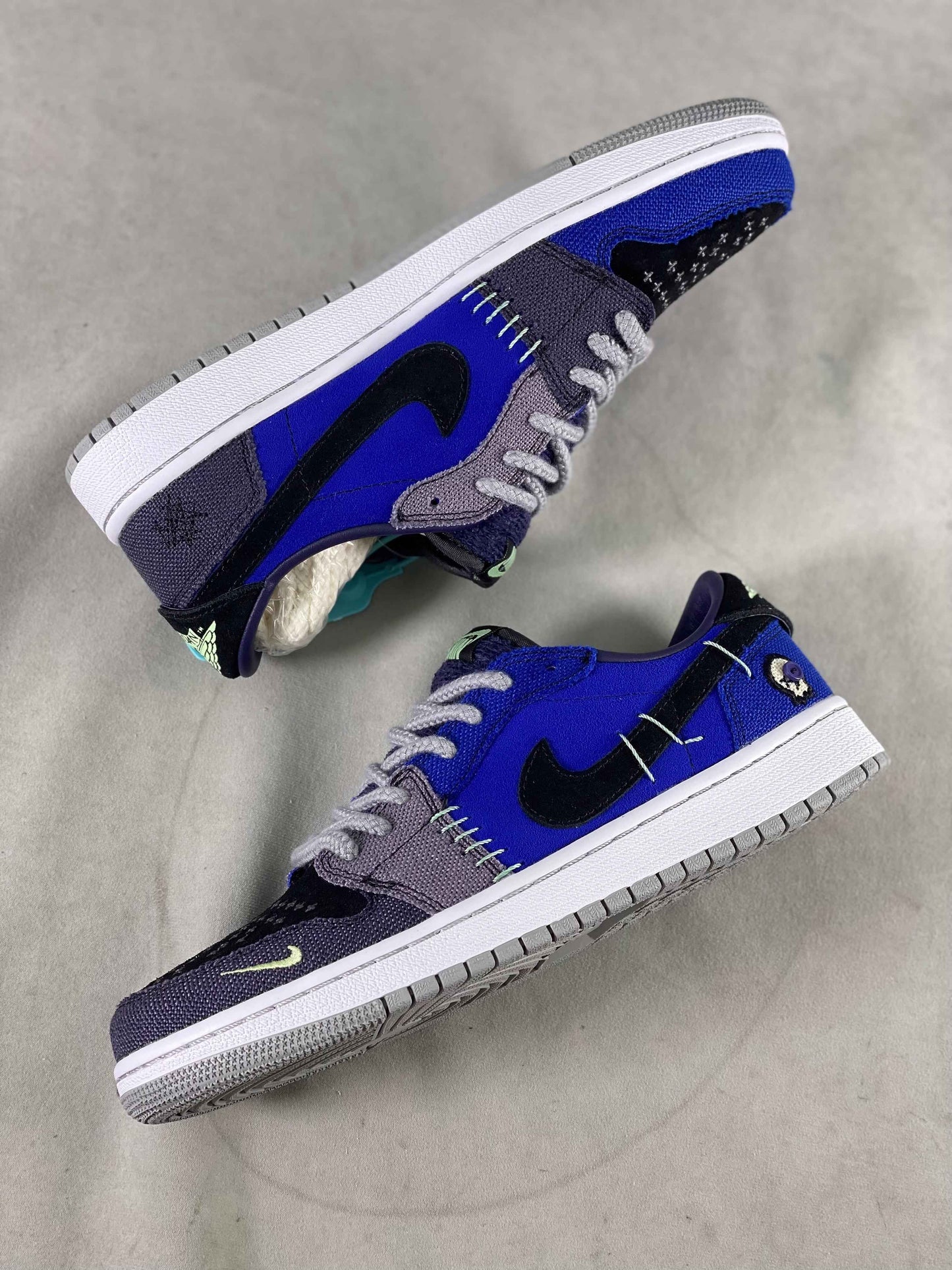 Luxury urban wear sneakers in blue, black, and gray with designer stitching details