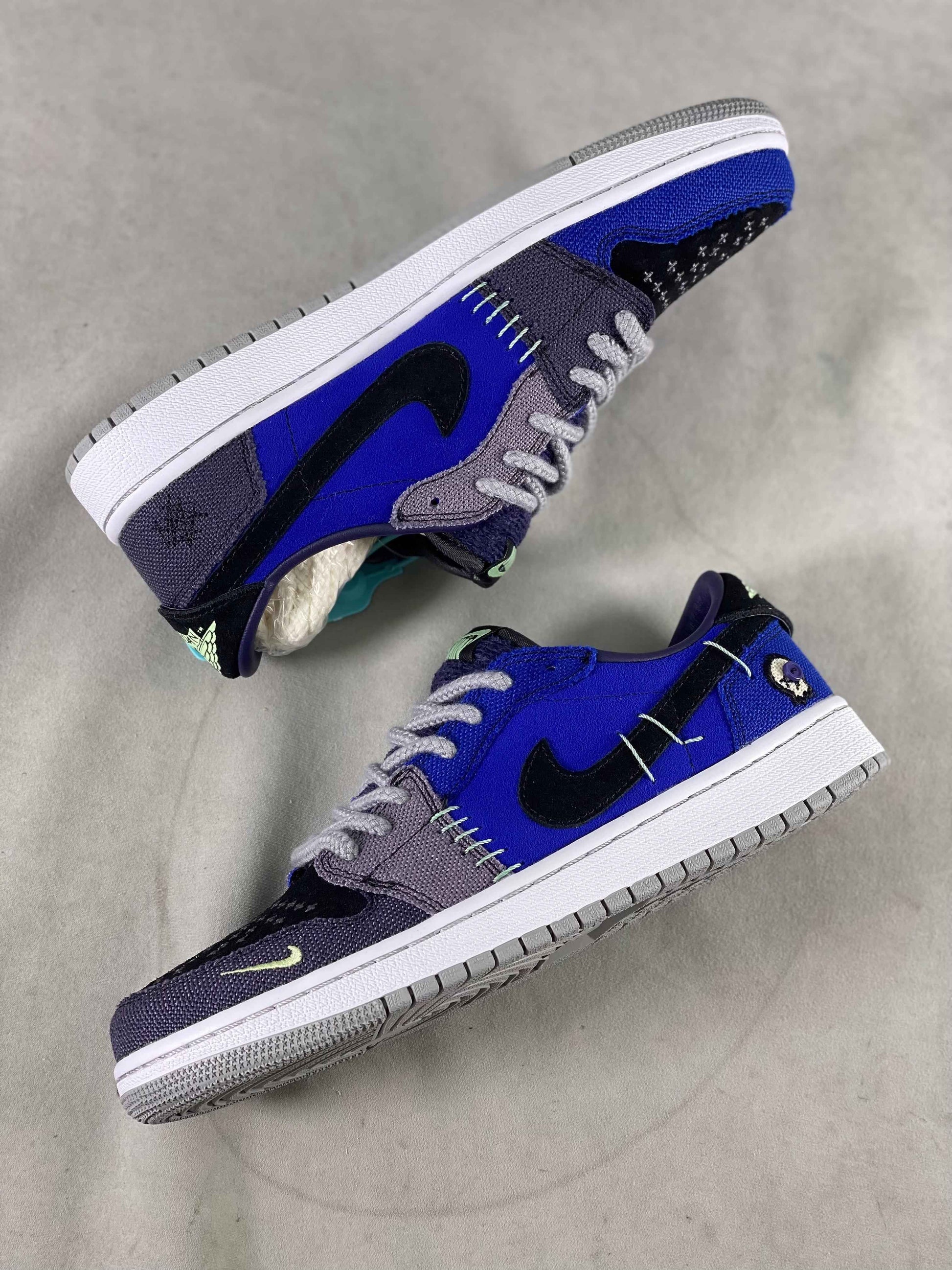 Luxury urban wear sneakers in blue, black, and gray with designer stitching details