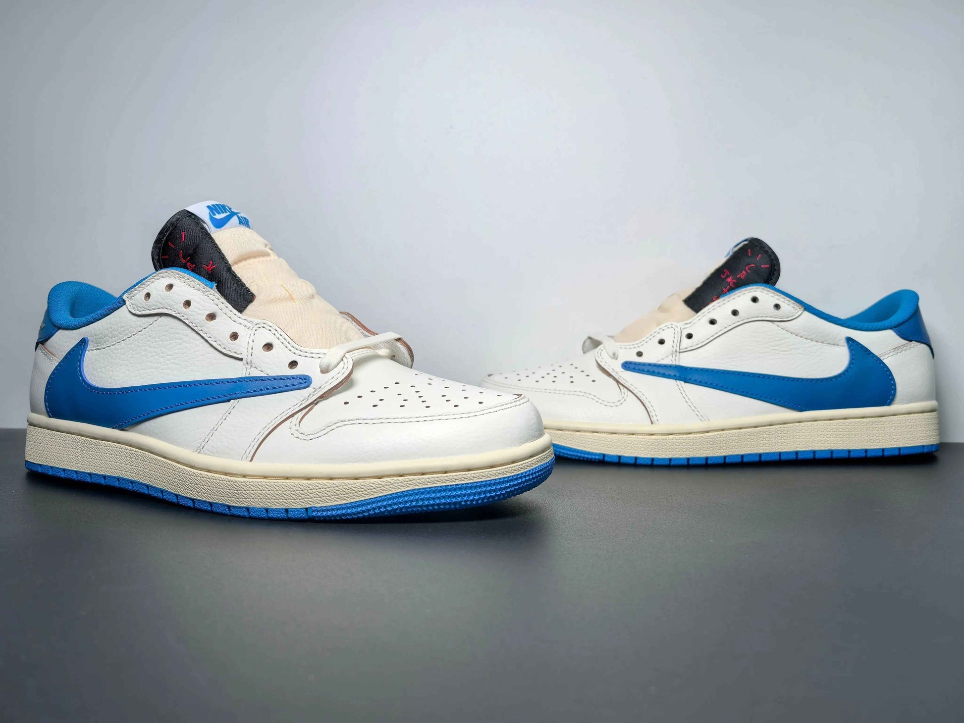 White and blue luxury urban sneakers with premium leather, displayed on a dark surface